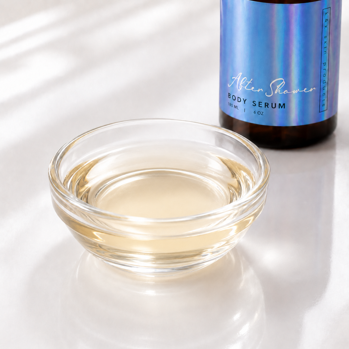 After Shower Body Serum oil texture in a glass bowl