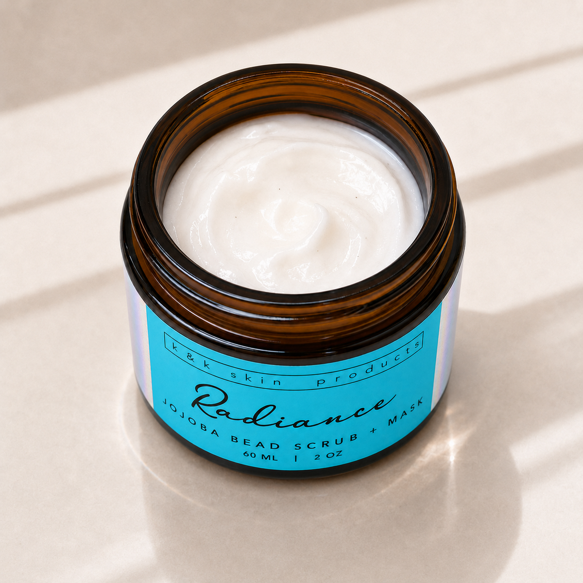 Radiance Jojoba Bead Scrub & Mask texture with jojoba beads in a glass bowl