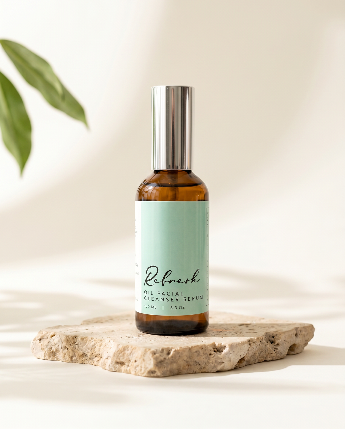 Refresh Oil Facial Cleanser Serum bottle on a granite surface