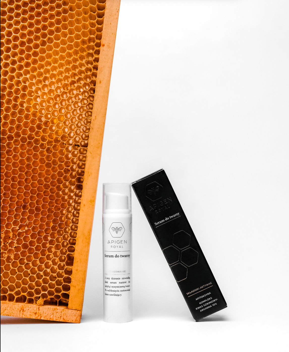 A skincare product, Bee Venom Serum, in a clear bottle with a white label, is displayed next to a black box and a representation of a honeycomb, suggesting the natural origin of the product.
